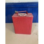 A Shell Motor Spirit petrol can, painted red with white highlights