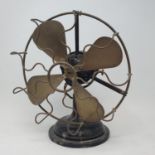 A 1920s desktop fan, on a round base, 33 cm high