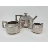 An Aesthetic Period silver plated three piece tea service, decorated in Japanese manner (3)