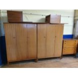 An Albert Cox bedroom suite, comprising two triple wardrobes 125 cm wide, a headboard, a chest, 84