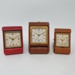 A 1920s travel clock by Jaeger, in leather case, 10 cm wide and two others (3) Other clocks made
