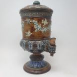 A Doulton Lambeth water filter, decorated festoons and birds 37 cm high Various losses to the lid