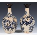 A pair of Doulton Lambeth vases, by George Tinworth, decorated stylised foliate form, incised mark