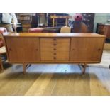 A 1970's teak dining room suite, comprising a sideboard, 181cm wide, an extending dining table,