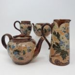 A Doulton Lambeth three piece tea set, and a similar jug, 20 cm high (4)