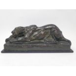 An Elsie Marian Henderson bronze figure, Young Tiger, with green patina, 31 cm wide, on a wooden