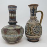 A Doulton Lambeth vase, decorated stylised foliate forms, 24 cm high, and a similar jug, 25 cm