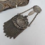 An early Art Noveau purse, decorated a female bust and flowers and a silver coloured metal