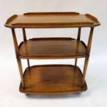 An Ercol three tier trolley, 73 cm wide, a G-Plan nest of three tables, 53 cm wide, and a coffee