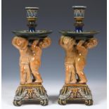 A pair of Royal Doulton stoneware candlesticks in the manner of George Tinworth, the columns in