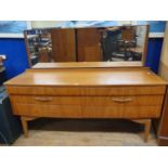 A teak dressing table, with six drawers, 152 cm wide