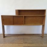 An Art Deco walnut wall shelf, with two sliding doors, 200 cm wide