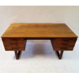 A Danish Dyrlund hardwood kneehole desk, with six drawers, 156 cm wide Height 71 cm Depth 75 cm