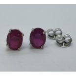 A pair of ruby stud earrings Treated rubies