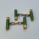 An unusual pair of gold and enamel cufflinks, in the form of green shotgun cartridges