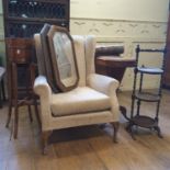 A 19th century walnut work table, a jardiniere stand, folding cake stand and a wing back armchair