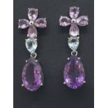 A pair of silver, amethyst and blue topaz drop earrings