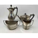An Edward VII silver four piece tea service, comprising a tea pot, coffee pot, sugar bowl, and a