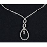 An 18ct white gold reverie style diamond set pendant necklace