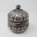 A Continental silver colour metal box, decorated flowers, 9 cm diameter 6.9 ozt, untested