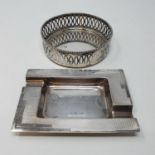 A silver ashtray, Sheffield, 1937 and a Continental silver coloured metal bottle coaster (2) 7tozs