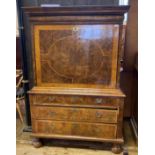 An 18th century escritoire, veneered in yew, the fall front to reveal cupboard drawers and pigeon