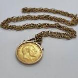 An Edward VII sovereign, in a yellow metal mount, on a 9ct gold chain, 20 g (all in)