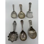 A George III silver caddy spoon, London 1791, four other silver caddy spoons and a Continental