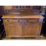 An oak sideboard, having two drawers above two cupboard doors, on bracket feet, 128 cm wide