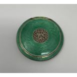 An Austrian silver guilloche and green enamel compact, the pierced top decorated flowers and