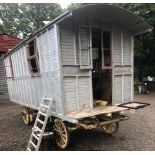 A gypsy style caravan, with a bowed top, the interior fitted with living accomodation, the chassis/