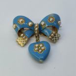 A gold, blue enamel and pearl bow brooch, with a heart shaped drop