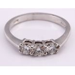 An 18ct white gold and three stone diamond ring, ring size M 1/2 Diamond ring approx. 0.52ct