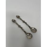 A pair of 18th century Dutch style silver coloured metal spoons, decorated figures, dolphins and