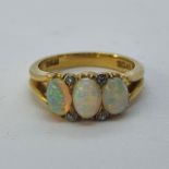 An 18ct gold, opal and diamond ring, ring size K