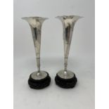 A pair of Chinese silver vases, decorated bamboo, on pierced and carved hardwood bases, 22 cm