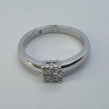 An 18ct white and gold four stone princess cut diamond ring, ring size M