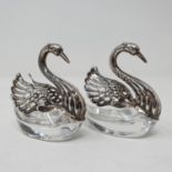 A set of two Continental silver and cut glass salts, in the form of swans, another in silver