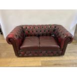 A red leather Chesterfield sofa, 161 cm wide