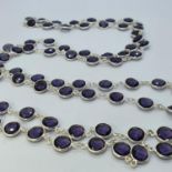 A silver and facet cut amethyst necklace