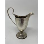 A George III cream jug, London 1784, 3 ozt, 14 cm high Marks rubbed, some over polishing and loss of