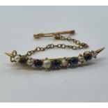 An early 20th century yellow coloured metal, seed pearl, and aquamarine crescent brooch Total length