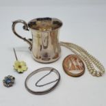 A cameo brooch, in yellow metal mount, a hat pin in the form of a flower, a silver mug, and a bead