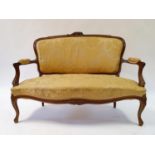 A Continental walnut settee, 130 cm wide One arm a bit wobbly, lacks small area to carving on