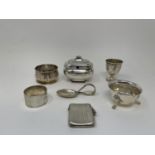 A silver mustard pot, vesta, two salts, baby's spoon, egg cup, and a napkin ring, various dates