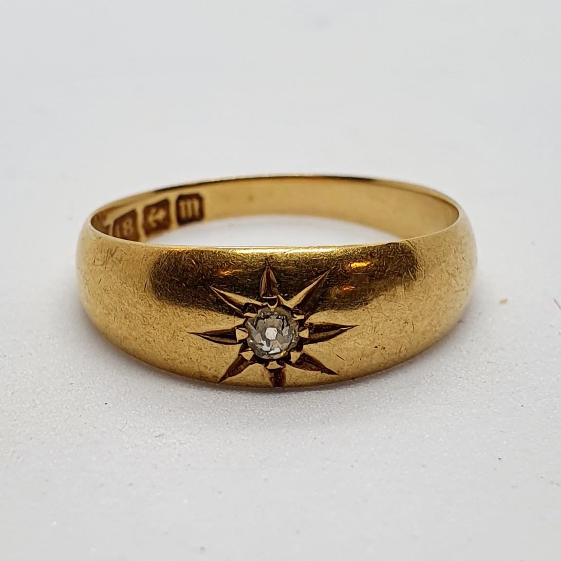 An 18ct gold and diamond gypsy set ring, 3.8 g