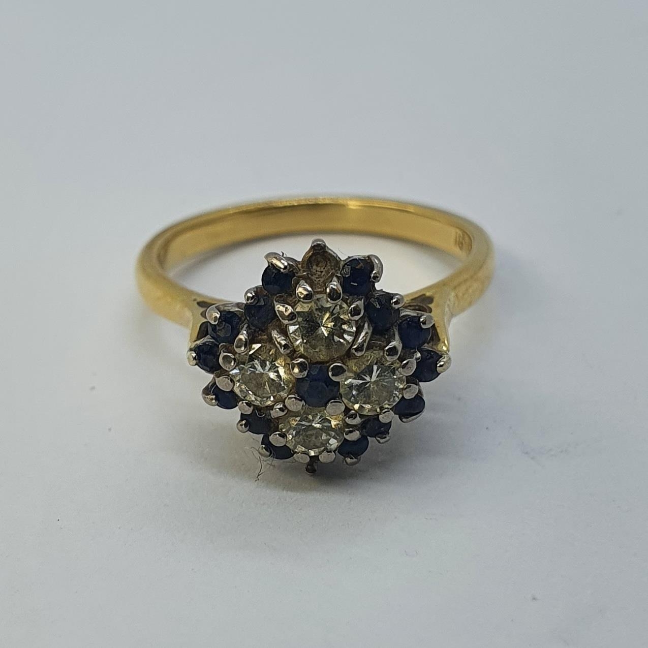 An 18ct gold, sapphire and diamond cluster ring, ring size G 1/2 all in weight 4.3 g