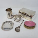 A George V silver mug, engraved Nancy, a cigarette box, a silver backed brush, a spoon, a pin