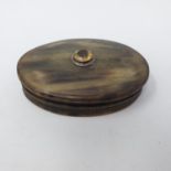 A 19th century horn oval snuff box, the top inset with a yellow gemstone, 10 cm wide Faded