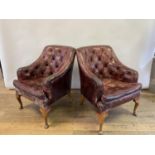 A pair of George Smith red leather button back armchairs, on beech cabriole legs (2) George Smith